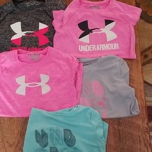 Five under armour shirts. Dry fit material.